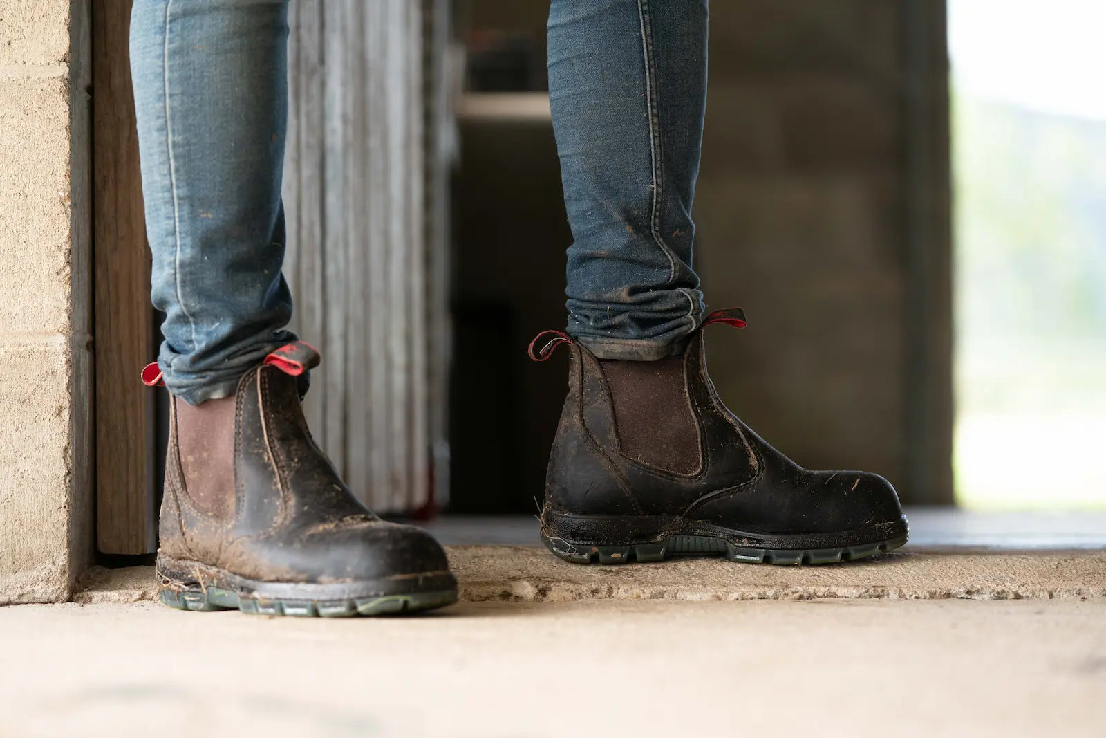 Dirty pair of Redback Bobcat leather work boots before cleaning