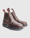 Pair of light brown leather chelsea boots on a light gray background
