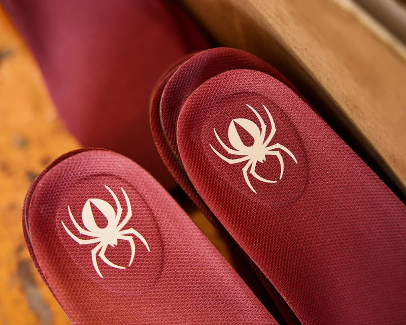 redback red insoles with redback logo on a wooden surface