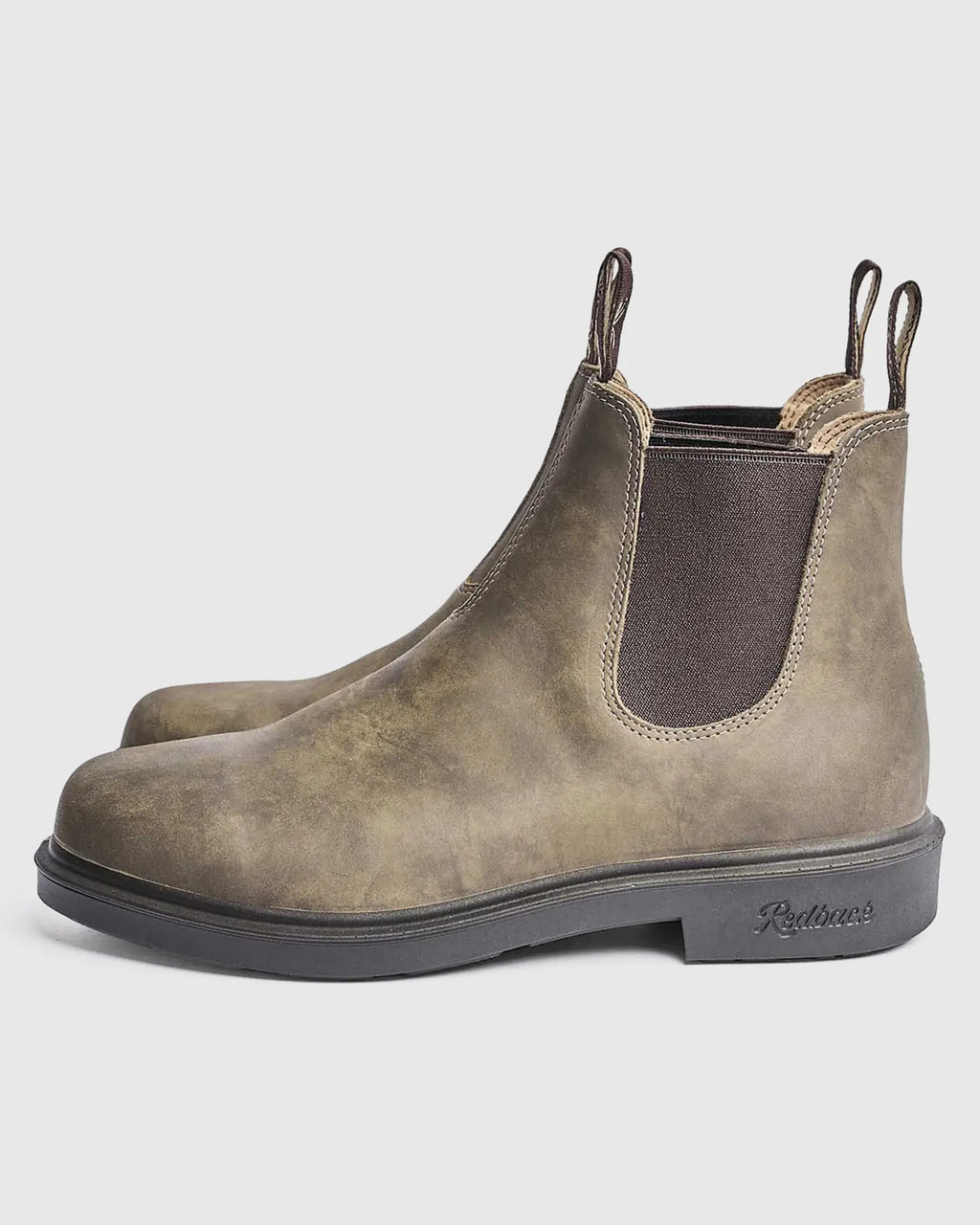 Pair of iron bark leather Chelsea boots on a light gray background from side view